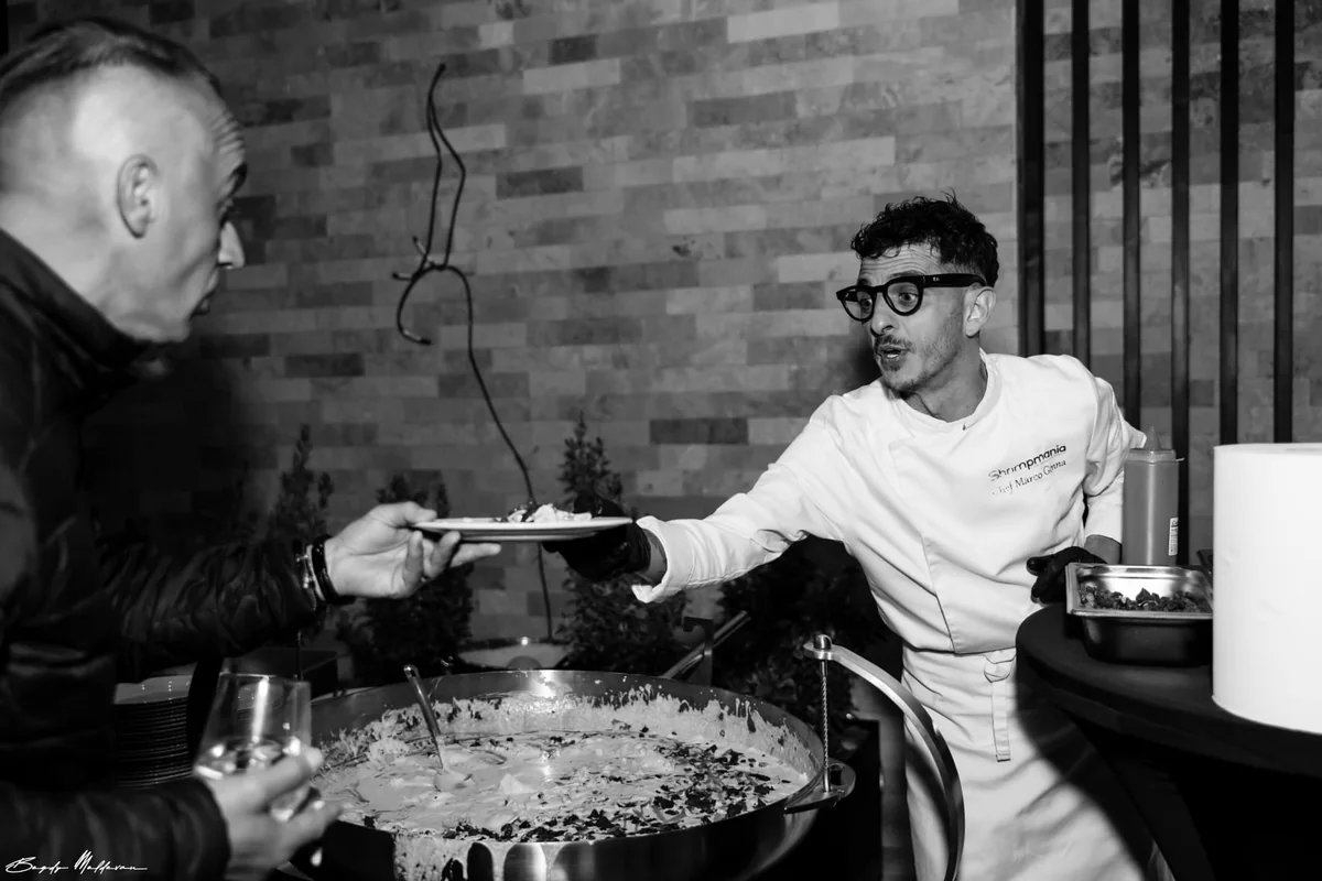Marco Genna working a pass in a restaurant kitchen