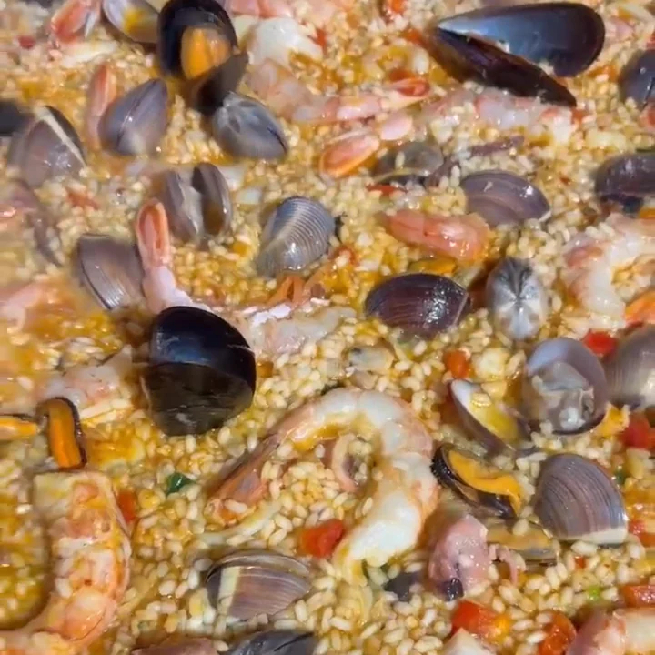 Seafood paella — mussels, prawns and clams in saffron rice